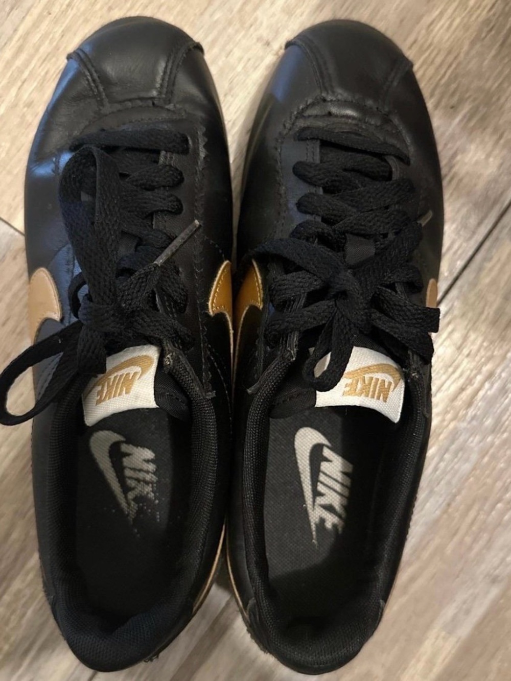 Nike Women’s Black Sneakers with Gold Swoosh